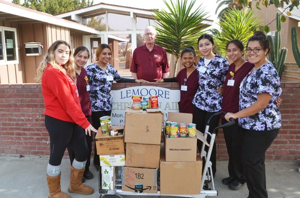 The LHS Nursing Program donated canned goods to Lemoore Christian Aid. Members (L to R) are Jewels Halkum, Rhema Delcampo, Alejandra Khan, LCA Director Nick Francu, MJ Bresenio, Jeanette Cisneros, Amy Nunez, Jade Jaramillo.
